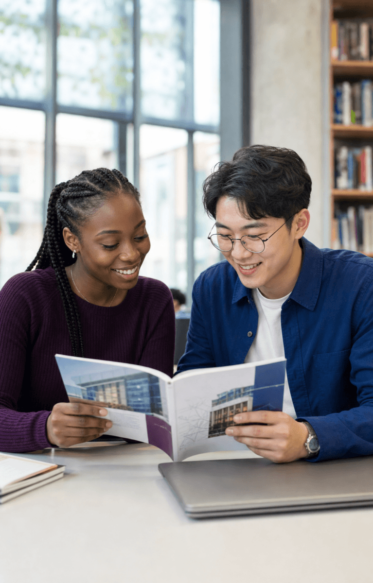 Two university students reviewing study programmes together